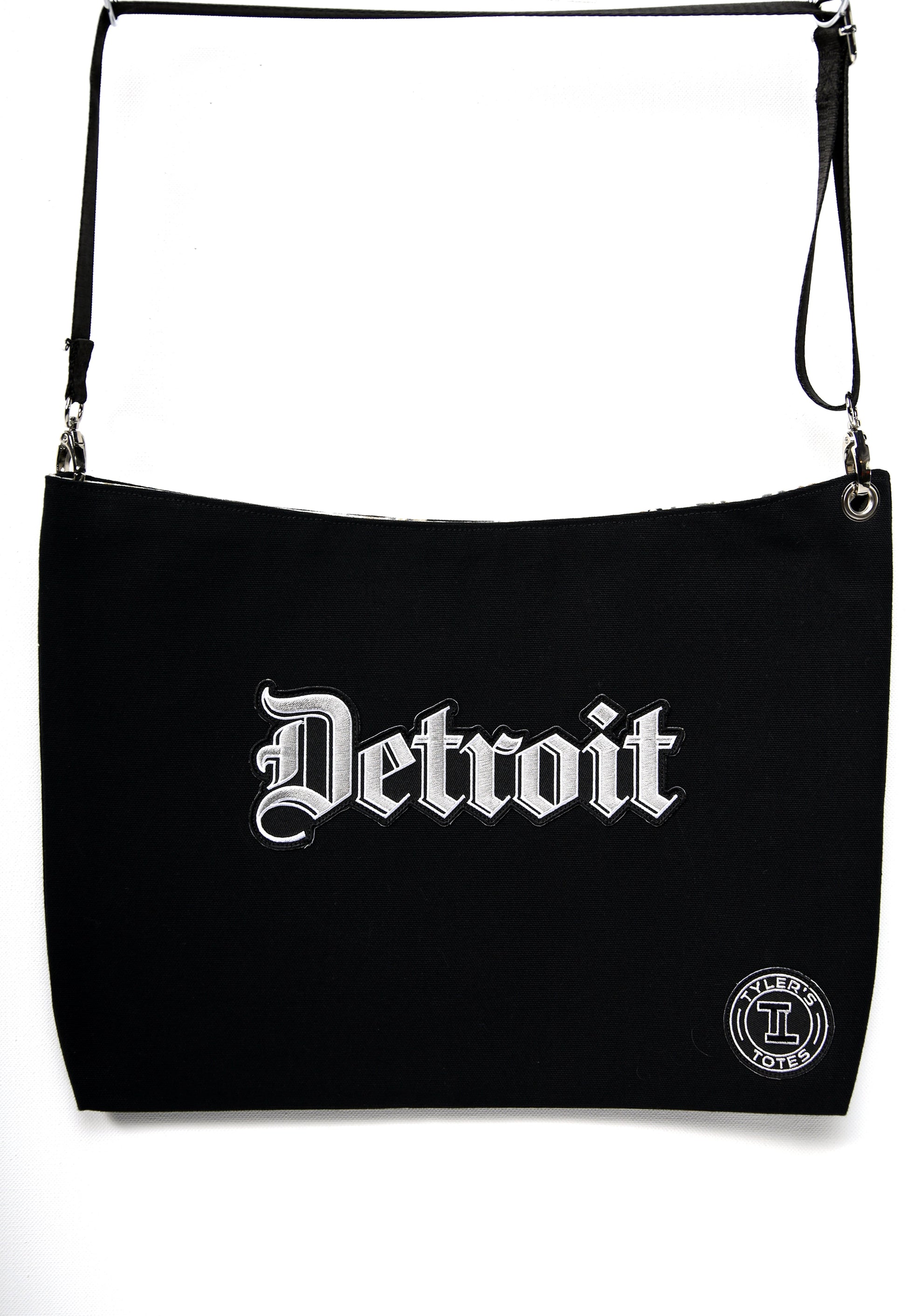 Black square tote with "Detroit" patch in Old English font.