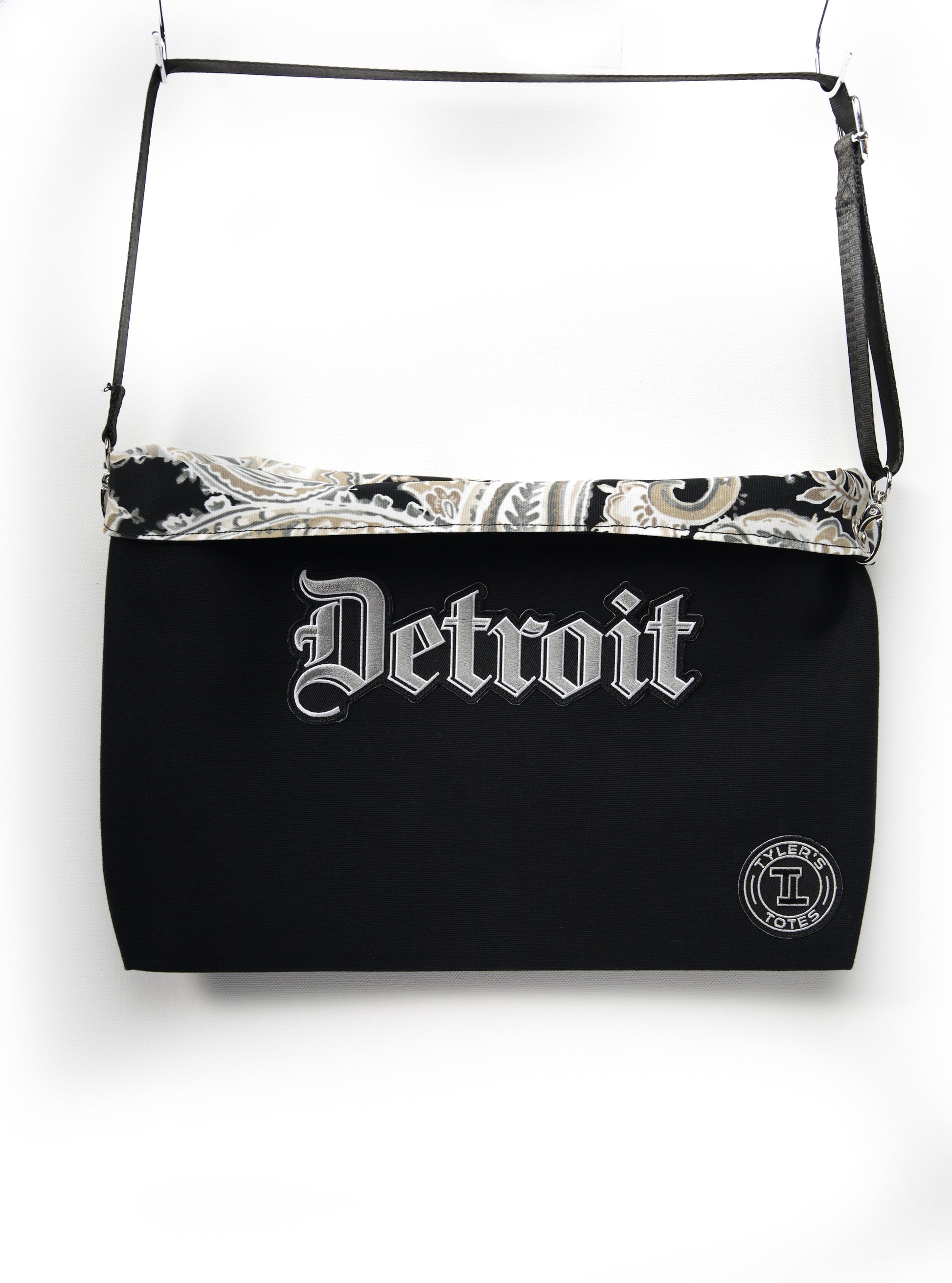 Black square tote with "Detroit" patch in Old English font and paisley interior.
