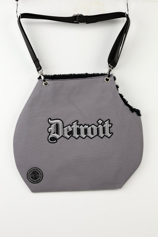 Grey canvas tote pet carrier with faux fur interior and "Detroit" patchwork.